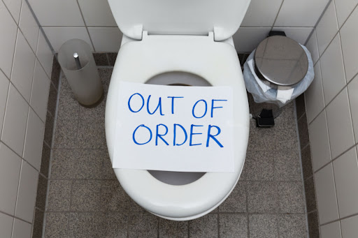 out of order sign over toilet seat