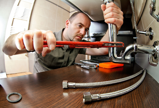 A plumber performing vital maintenance on the plumbing system